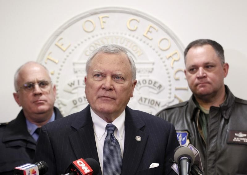 © Reuters. Georgia Governor Deal speaks to the media as Public Safety Director McDonough and Georgia National Guard Director Butterworth listen at the State Capitol in Atlanta