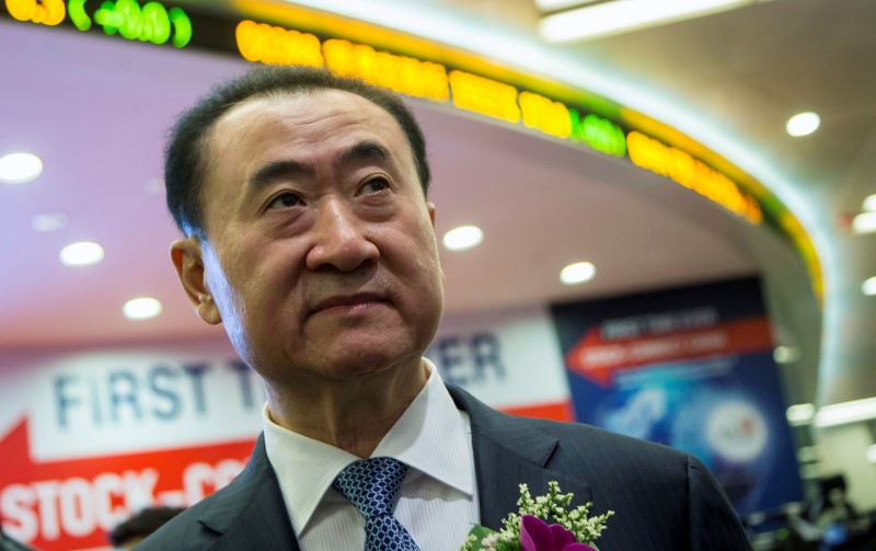 © Reuters. Wang Jianlin, chairman of Wanda commercial properties, attends a ceremony during the debut of the company at the Hong Kong Stock Exchange