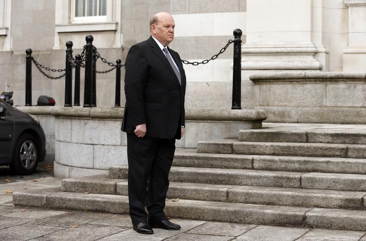 © Reuters. Minister for Finance Michael Noonan waits by the steps of Government Buildings in Dublin