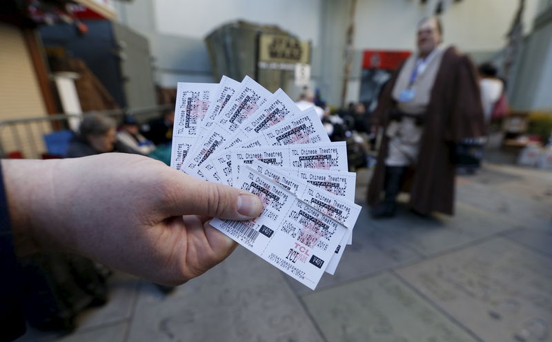 © Reuters. A person shows tickets for the first showing of 