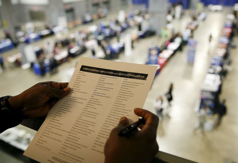 © Reuters. Person looks over firms interviewing at a 