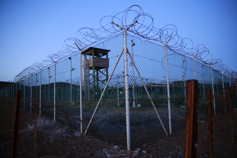 © Reuters. Chain link fence and concertina wire surrounds a deserted guard tower within Joint Task Force Guantanamo's Camp Delta