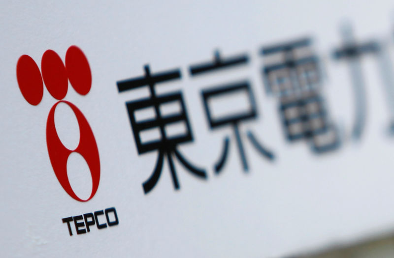 © Reuters. A TEPCO logo is pictured on a sign showing the way to the venue of the company's annual shareholders' meeting in Tokyo