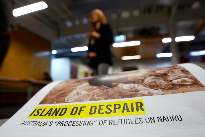 © Reuters. Anna Neistat, Senior Director for Research with Amnesty International, talks to journalists behind a copy of a report she co-authored titled 'Island of Despair - Australia's "Processing" of Refugees on Nauru' in Sydney, Australia