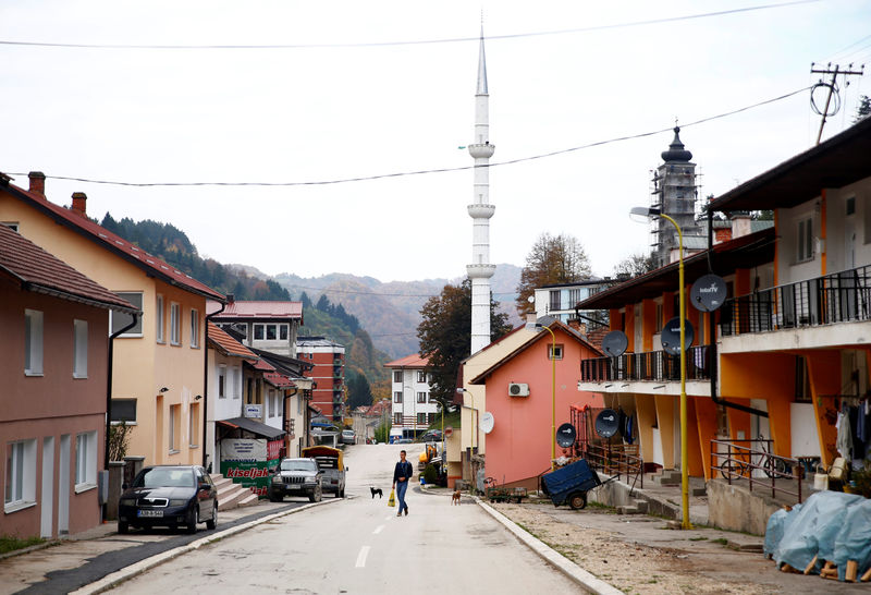 © Reuters. A man walks on the street in Srebrenica