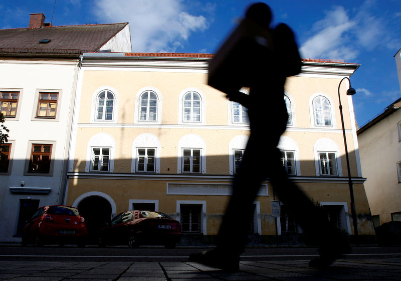 © Reuters. A person passes the house in which Adolf Hitler was born in Braunau am Inn