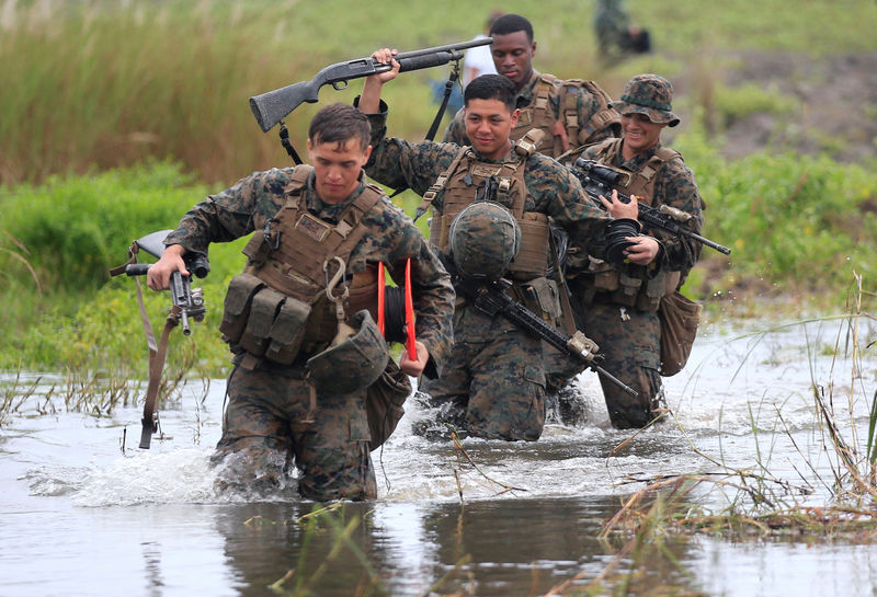 © Reuters. U.S. military forces cross a flooded area near the shore during the annual Philippines-US amphibious landing exercise (PHIBLEX) at San Antonio