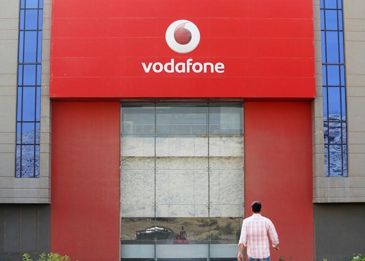 © Reuters. A man walks past Vodafone Egypt Telecommunications Co in the Cairo