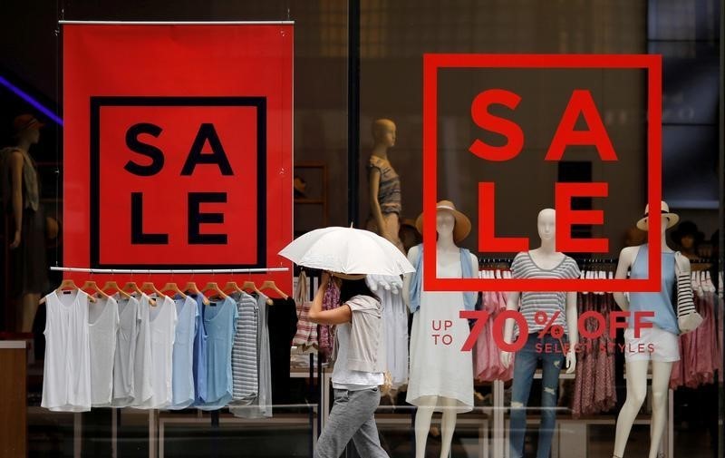 © Reuters. A woman walks past a fashion boutique in a shopping district in Tokyo