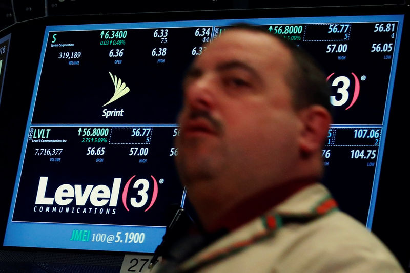 © Reuters. A trader passes by the post where Level 3 Communications is traded on the floor of the NYSE