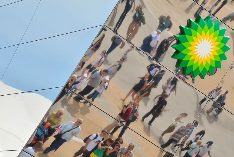 © Reuters. Spectators are seen reflected in a British Petroleum sponsors building in Olympic Park at the London 2012 Paralympic Games