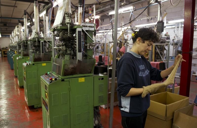 © Reuters. An employee works in a stocking factory in Calvisano near Brescia