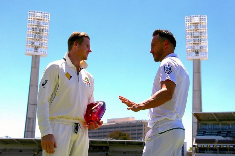 © Reuters. Australian cricket team captain Steve Smith talks with South Africa's captain Faf du Plessis after posing with the series trophy at the WACA Ground in Perth