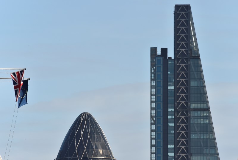 © Reuters. A British Union Jack flag and an European Union flag fly from a building, with the 'Gherkin'  and Leadenhall Building skyscrapers seen in the City of London financial district in London, Britain