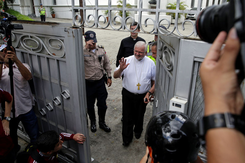 © Reuters. Apostolic Nuncio to Venezuela Archbishop Aldo Giordano greets the media as he leaves the Apostolic Nunciature building to meet with students during a rally in Caracas