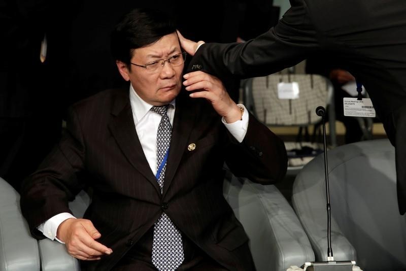 © Reuters. An aid adjusts a hair of Chinese Finance Minister Lou Jiwei before the Development Committee meeting in Washington