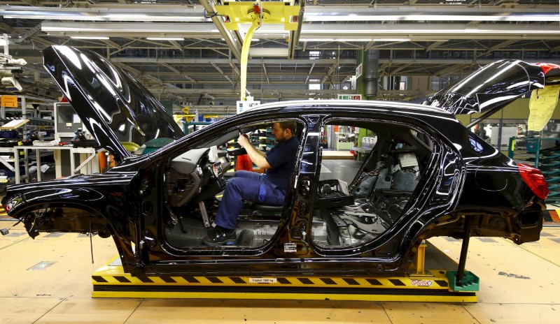 © Reuters. File photo of an employee of German car manufacturer Mercedes Benz working on the interior of a GLA model at their production line at the factory in Rastatt