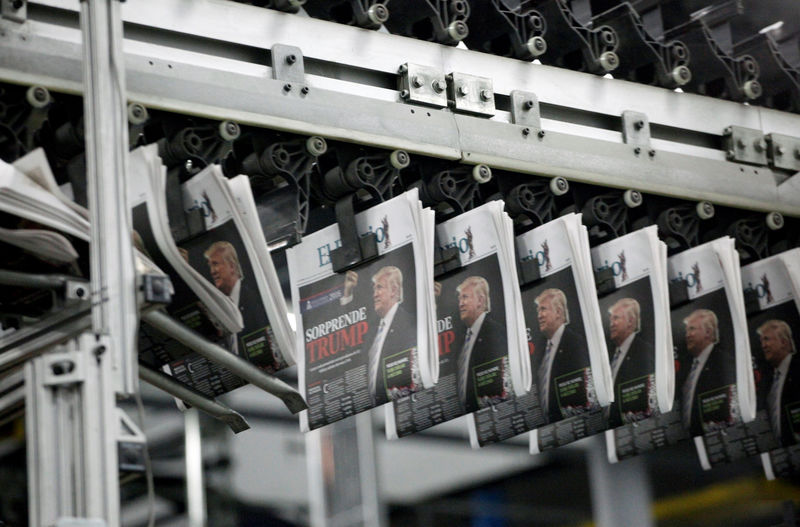 © Reuters. Freshly printed newspapers with the headline reading "Trump surprises" are seen at a conveyer belt at a printer of the local daily El Diario of Juarez in Ciudad Juarez