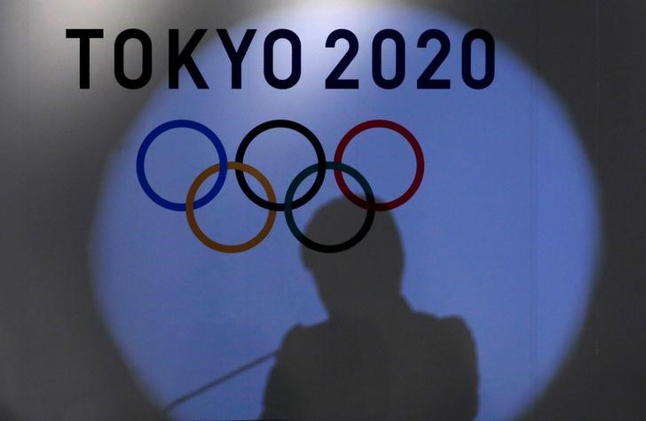 © Reuters. Shadow of of Tokyo governor Yuriko Koike is seen on the logo of Tokyo 2020 Olympic games during the Olympic and Paralympic flag-raising ceremony at Tokyo Metropolitan Government Building in Tokyo