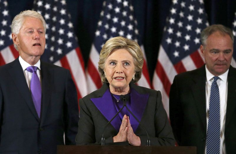 © Reuters. Democratic presidential candidate Hillary Clinton, husband, former U.S. President Bill Clinton, and VP nominee Kaine, listen to her concession speech in New York