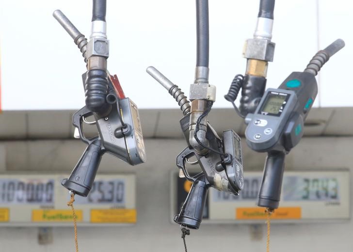 © Reuters. Fuel pumps hang at a gasoline station in Metro Manila