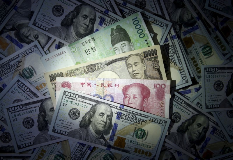 © Reuters. File photo illustration of South Korean won, Chinese yuan and Japanese yen notes seen on U.S. 100 dollar notes