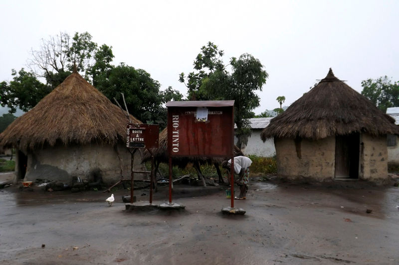 © Reuters. A mailbox donated by mining corporation Rio Tinto stands in front of huts outside Beyla