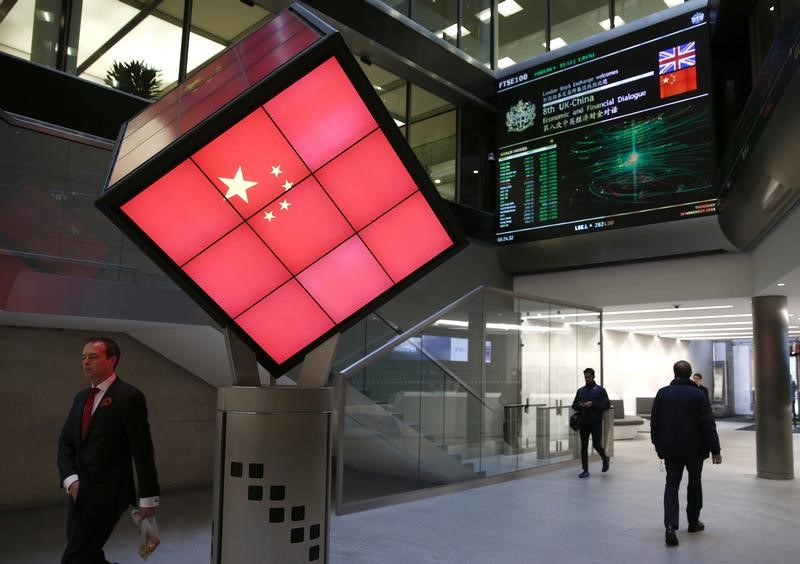 © Reuters. An illuminated cube bearing the Chinese flag is seen in the entrance foyer of the London Stock Exchange in London