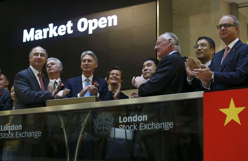 © Reuters. Britain's Chancellor of the Exchequer Philip Hammond (3rd L), opens the London Stock Exchange