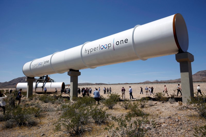 © Reuters. Journalists and guests look over tubes following a propulsion open-air test at Hyperloop One in North Las Vegas