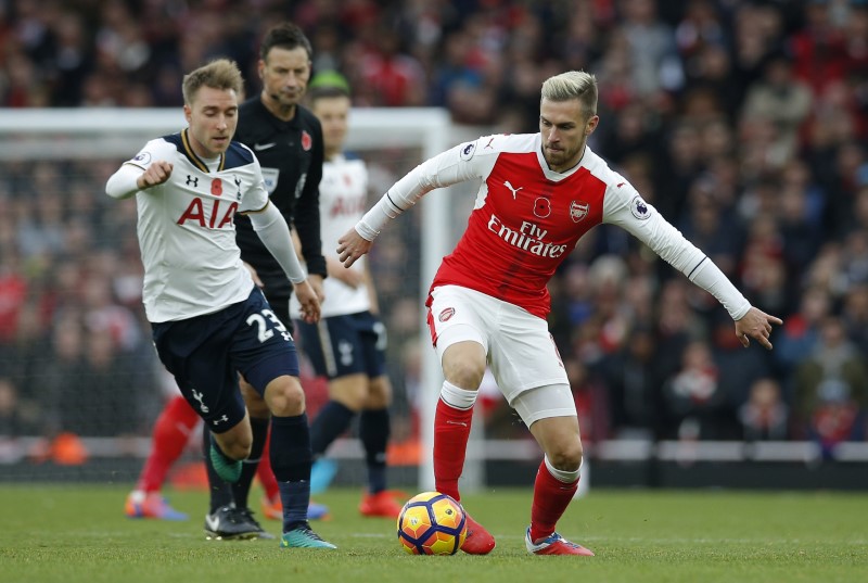 © Reuters. Tottenham's Christian Eriksen in action with Arsenal's Aaron Ramsey