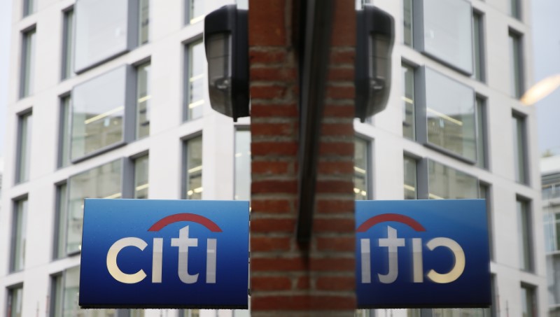 © Reuters. A Citibank sign is reflected in a window in the City of London