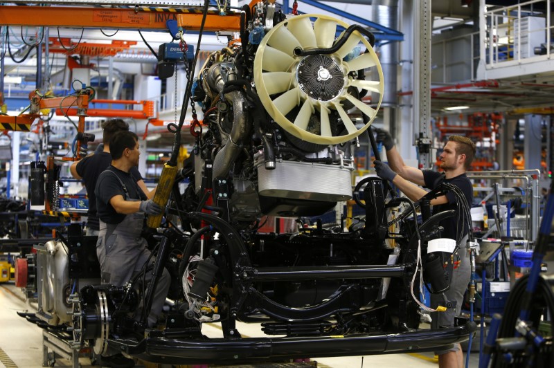 © Reuters. Men work at the assembly line in the truck production plant of truck and bus-maker MAN AG in Munich