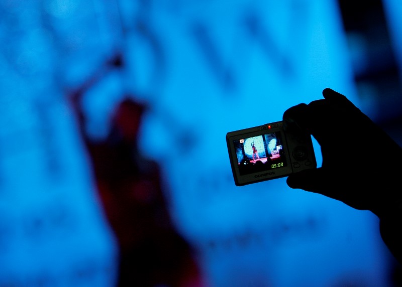 © Reuters. Visitor takes pictures of adult film actress during Eros Show in Sofia