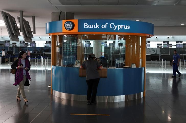 © Reuters. A passenger makes a transaction at a branch of Bank of Cyprus at the departures building of Larnaca Airport in Larnaca