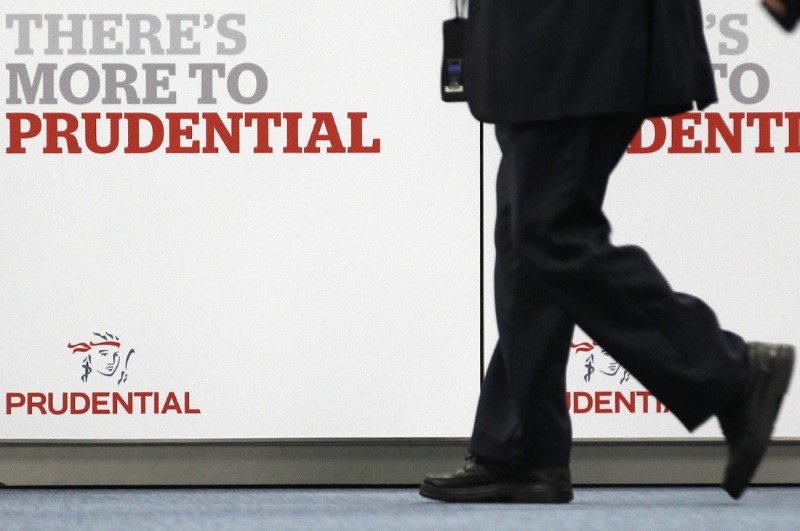 © Reuters. Shareholder arrives at Prudential's annual general meeting in central London