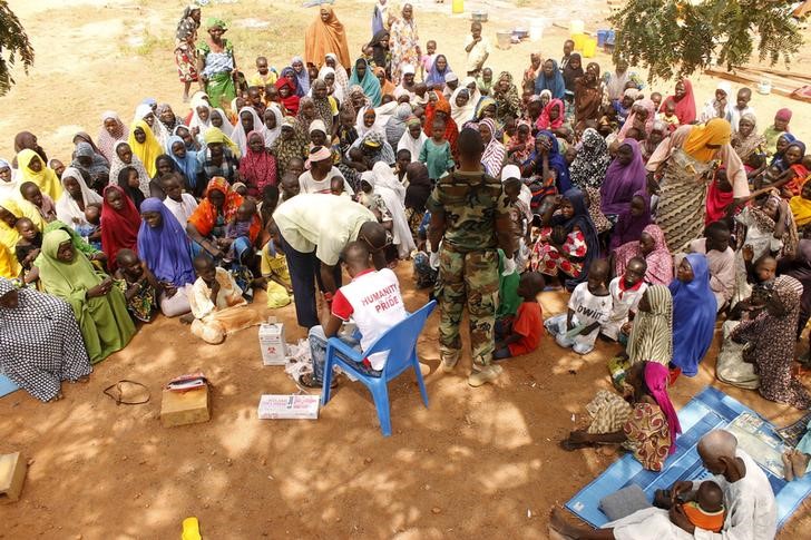 © Reuters. People who were rescued after being held captive by Boko Haram, sit as they wait for medical treatment at a camp near Mubi