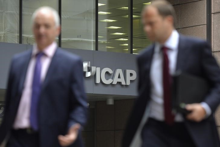 © Reuters. People walk past an ICAP office in the City of London