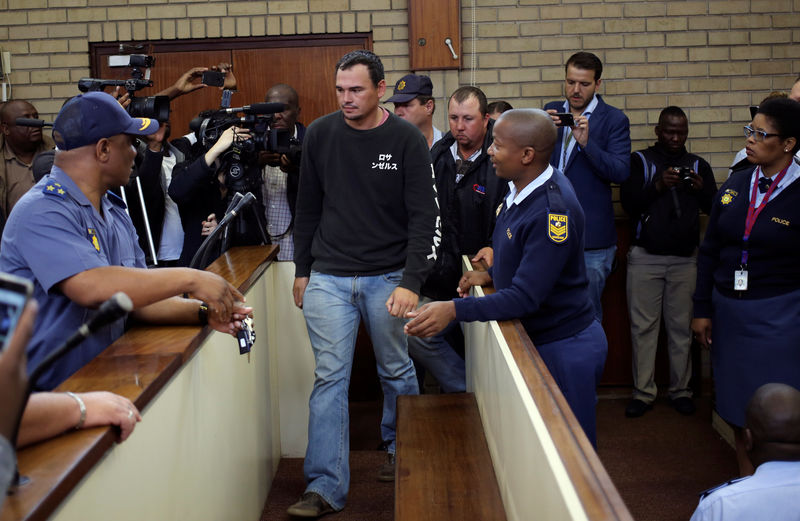 © Reuters. Theo Martins and Willem Oosthuizen appear in court at the Middelburg magistrates high Court, in Mpumalanga province, South Africa