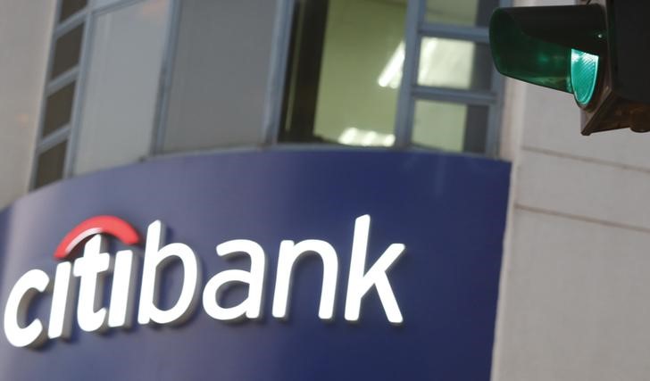 © Reuters. A green traffic light is pictured in front of a sign board of Citibank in Hanoi