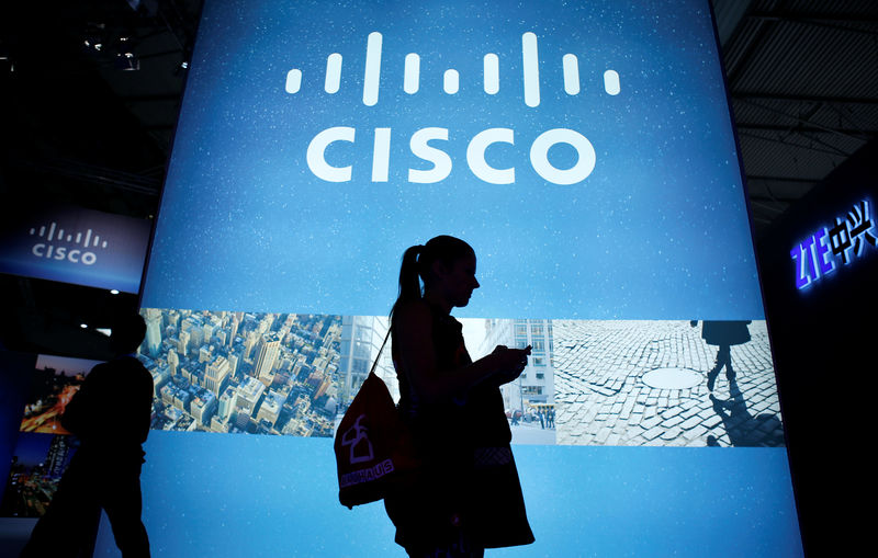 © Reuters. File photo of a visitor walking past a Cisco advertising panel at the Mobile World Congress in Barcelona
