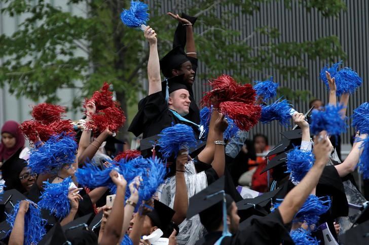 © Reuters. Graduating students of the CCNY cheer during the College's commencement ceremony in the Harlem section of Manhattan, New York