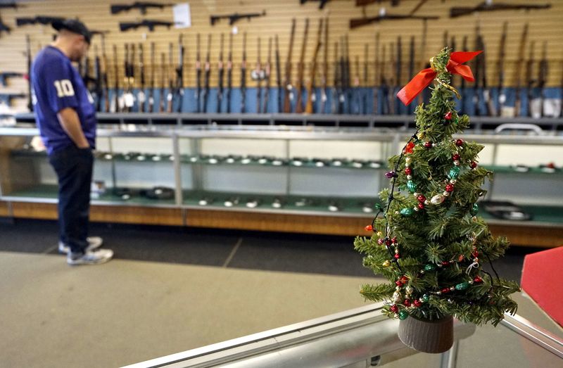 © Reuters. File photo of a Christmas tree sitting on the counter at the Pony Express Firearms shop in Parker
