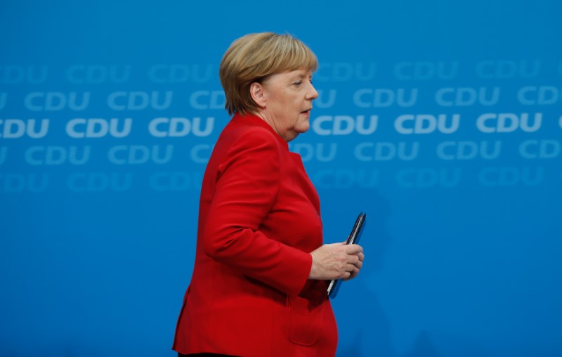 © Reuters. German Chancellor Angela Merkel leaves a news conference at the CDU headquarters in Berlin
