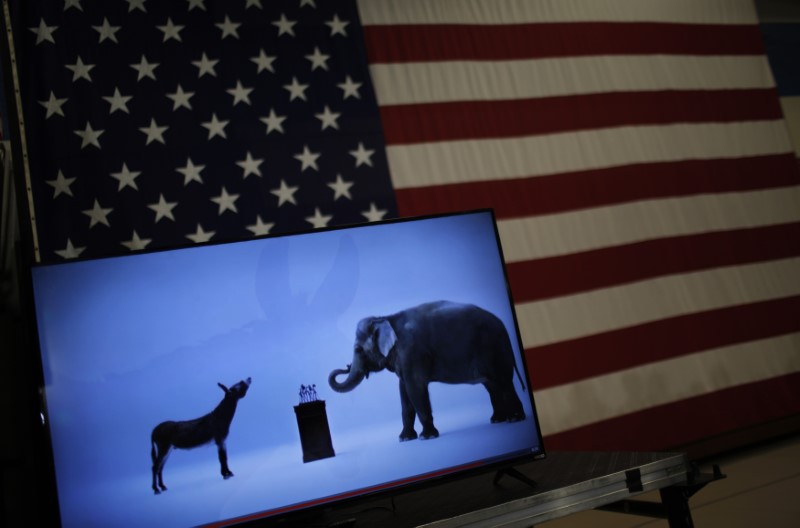 © Reuters. The mascots of the Democratic and Republican parties are seen on a video screen at Democratic U.S. presidential candidate Hillary Clinton's campaign rally in Cleveland