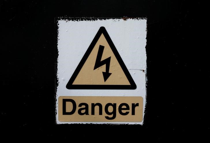 © Reuters. A warning sign is seen near an electricity pylon in Nottingham