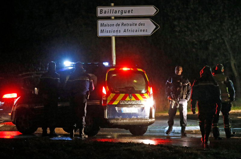 © Reuters. French gendarmes stand guard near a retirement home in Montferrier-sur-Lez, near Montpellier