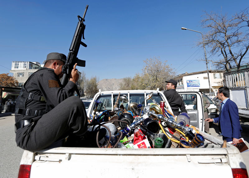 © Reuters. Water pipes are seen at the back of a police vehicle after being seized during a raid confiscating shisha water pipes in Kabul