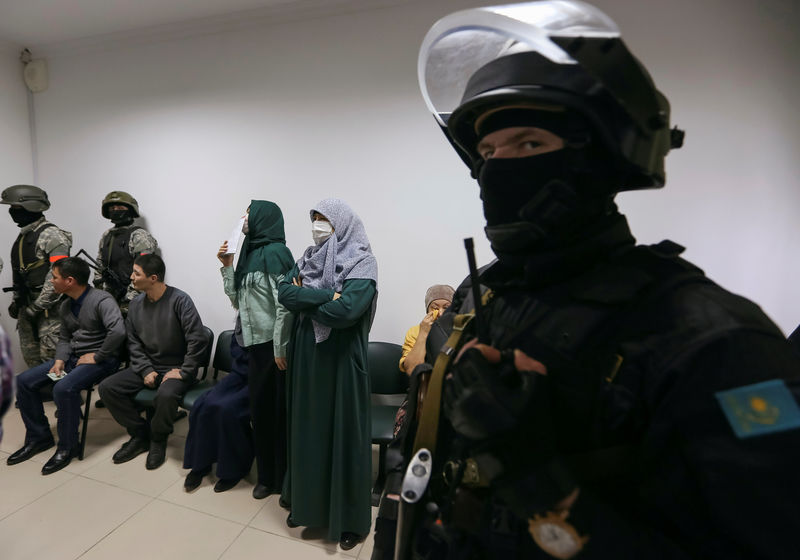 © Reuters. People attend a verdict hearing at a trial of Islamic State supporters, who attacked a National Guard facility in June, at a court in Aktobe