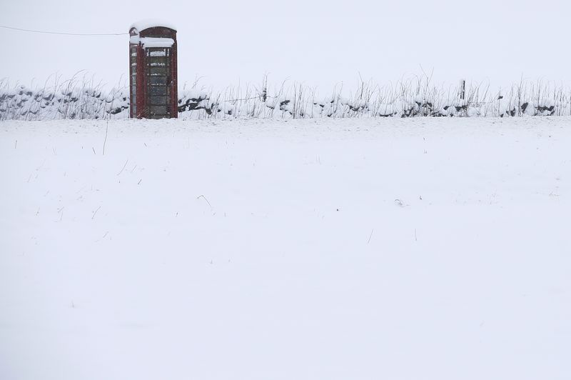 © Reuters. A phone box stands in snow in Newhaven